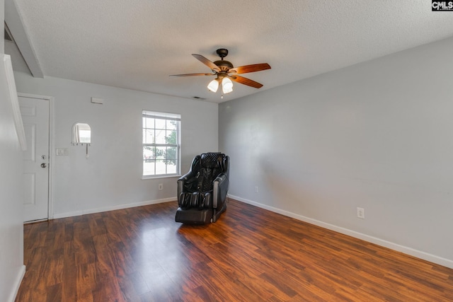 unfurnished room featuring a textured ceiling, wood finished floors, visible vents, a ceiling fan, and baseboards