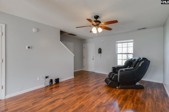 sitting room featuring baseboards, visible vents, and wood finished floors