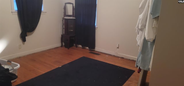 interior space with visible vents, baseboards, and wood finished floors