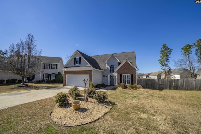 traditional-style house with a front yard, fence, concrete driveway, and brick siding