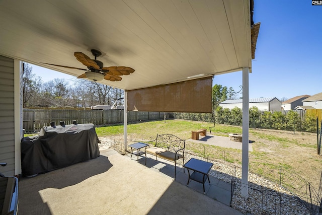 view of patio with an outdoor fire pit, a fenced backyard, a ceiling fan, and a grill