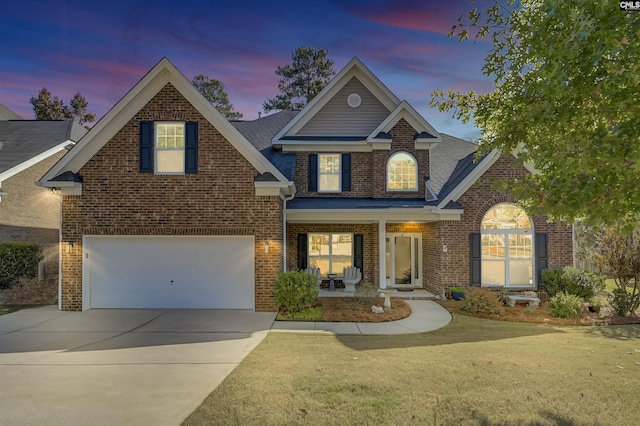 view of front of home with a yard, a porch, concrete driveway, and brick siding