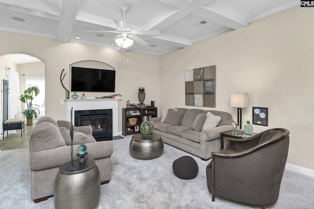 living room featuring baseboards, arched walkways, coffered ceiling, a fireplace with flush hearth, and beam ceiling