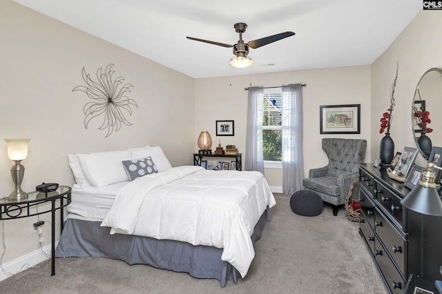 carpeted bedroom with baseboards and a ceiling fan