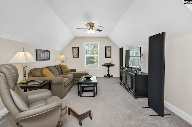 living room featuring baseboards, vaulted ceiling, a ceiling fan, and light colored carpet