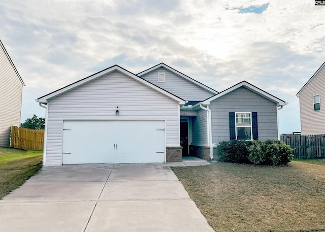 ranch-style home with a front lawn, fence, a garage, and driveway