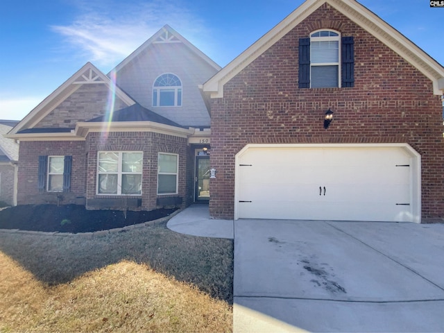 traditional home featuring a garage, concrete driveway, and brick siding