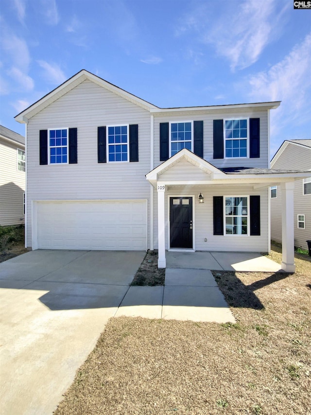 traditional-style house featuring a garage and driveway