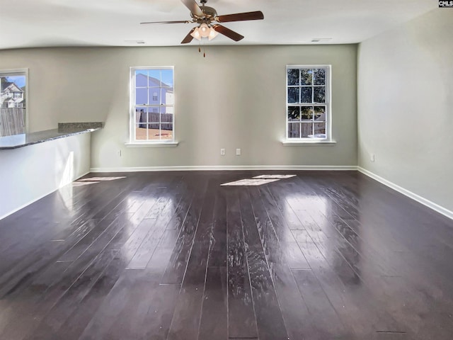 unfurnished room featuring baseboards, ceiling fan, and hardwood / wood-style floors