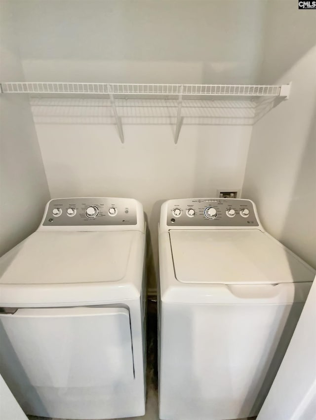 clothes washing area with laundry area and washing machine and clothes dryer