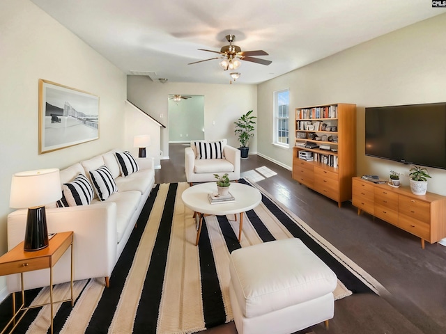 living area featuring ceiling fan, wood finished floors, and baseboards