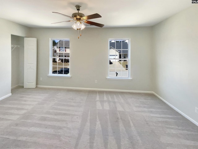 unfurnished bedroom with a ceiling fan, carpet, baseboards, and a closet