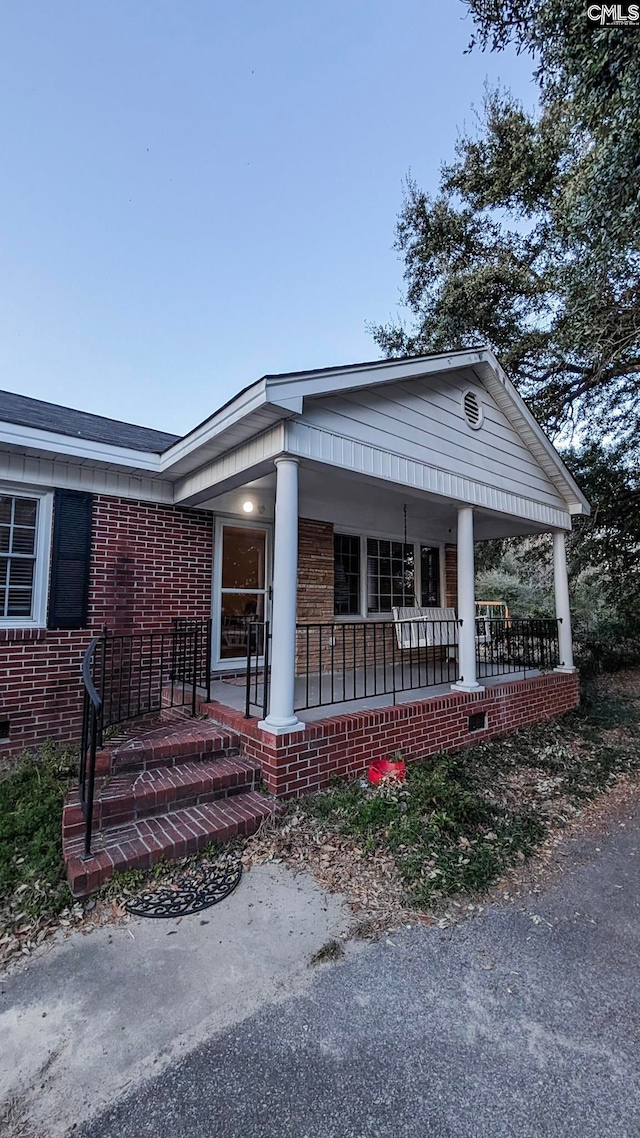 view of front facade with a porch and crawl space