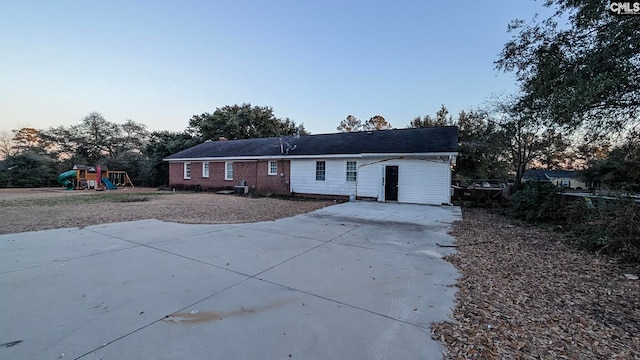 single story home featuring a playground