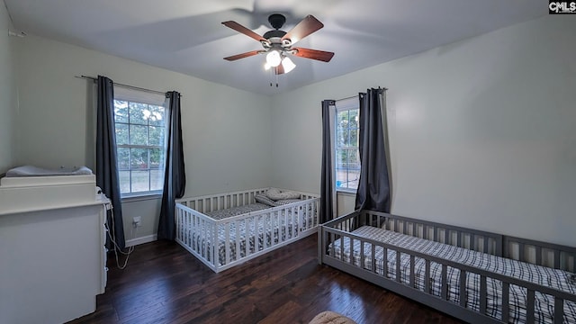 bedroom with a ceiling fan, baseboards, and wood finished floors