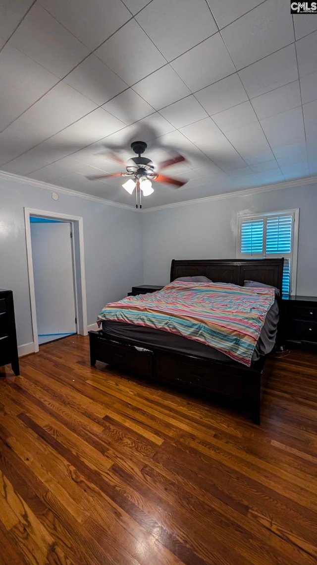 bedroom with ceiling fan, crown molding, and wood finished floors