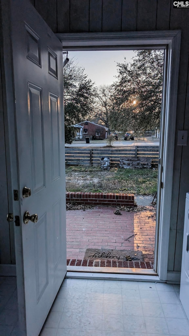 entryway featuring stacked washer and clothes dryer