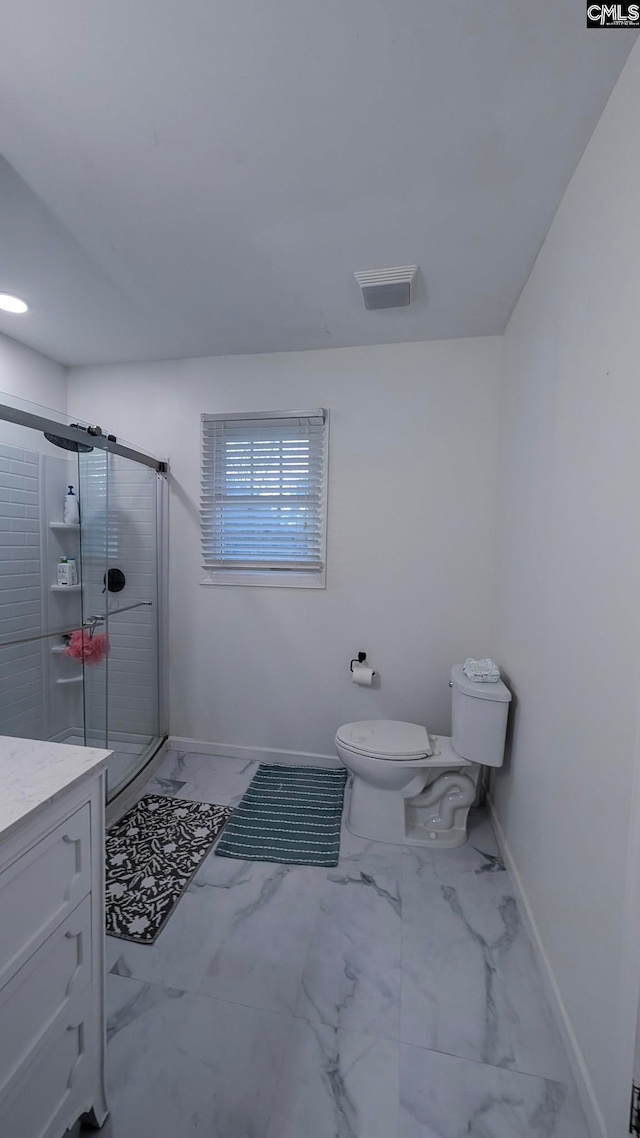 full bathroom featuring a stall shower, baseboards, toilet, marble finish floor, and vanity