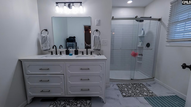 full bathroom featuring marble finish floor, a sink, and a shower stall