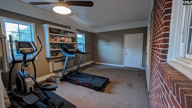 exercise room featuring carpet floors, an AC wall unit, and baseboards