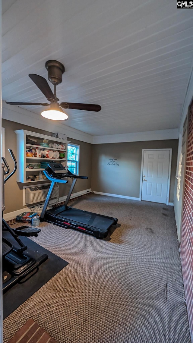 workout area with carpet floors, a ceiling fan, and baseboards