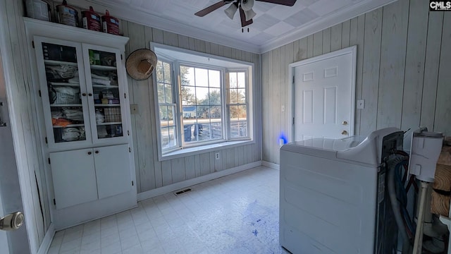 interior space with a ceiling fan, baseboards, visible vents, light floors, and crown molding