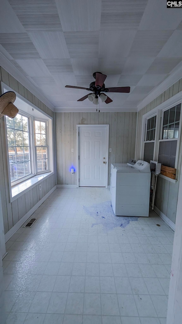 interior space featuring a ceiling fan, visible vents, crown molding, and separate washer and dryer