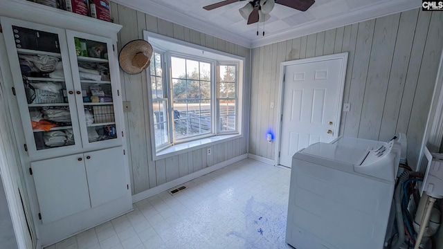 clothes washing area featuring crown molding, light floors, washing machine and clothes dryer, visible vents, and laundry area