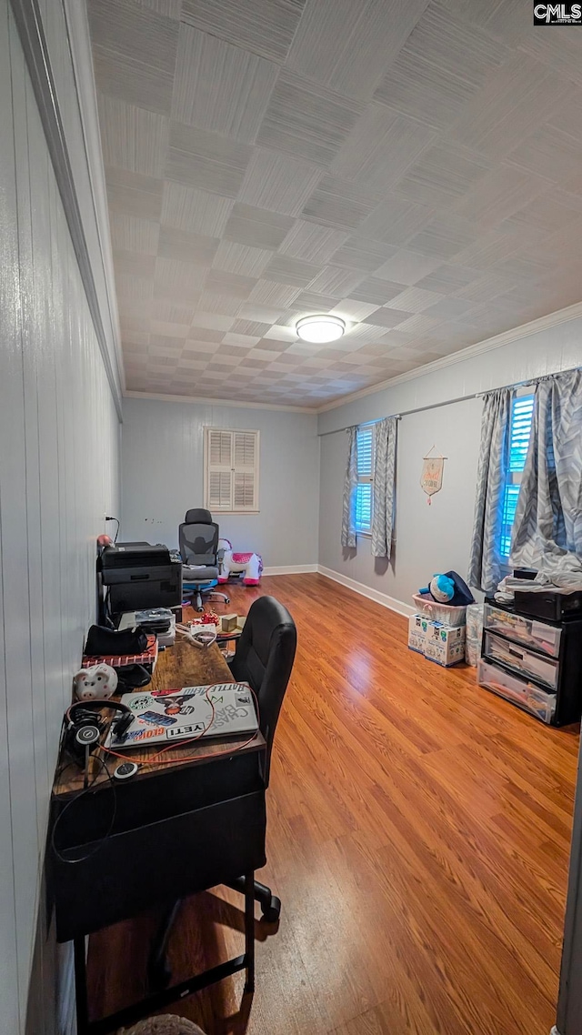 office area with ornamental molding, wood finished floors, and baseboards