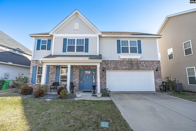 craftsman house with central air condition unit, a garage, brick siding, driveway, and a front yard