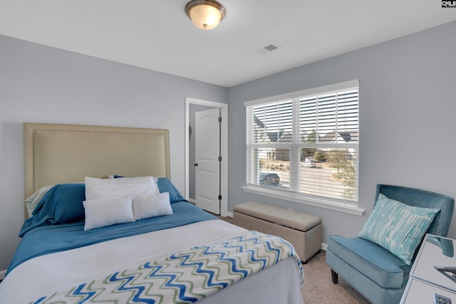 bedroom featuring light colored carpet and visible vents