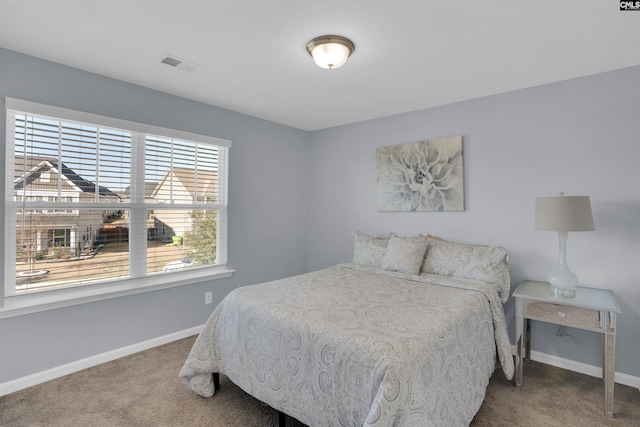 carpeted bedroom featuring visible vents and baseboards