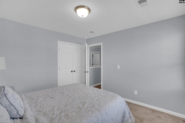 carpeted bedroom with baseboards, visible vents, and a closet