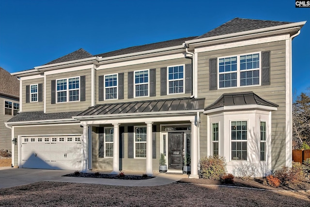 view of front facade featuring metal roof, concrete driveway, a shingled roof, and a standing seam roof