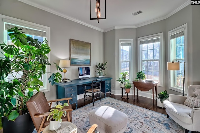 home office featuring plenty of natural light, visible vents, wood finished floors, and ornamental molding