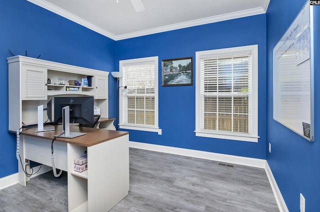 office area featuring visible vents, crown molding, baseboards, and wood finished floors