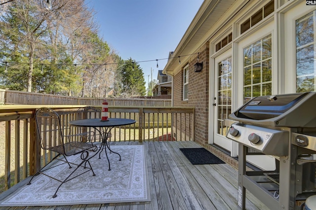 deck with fence and area for grilling