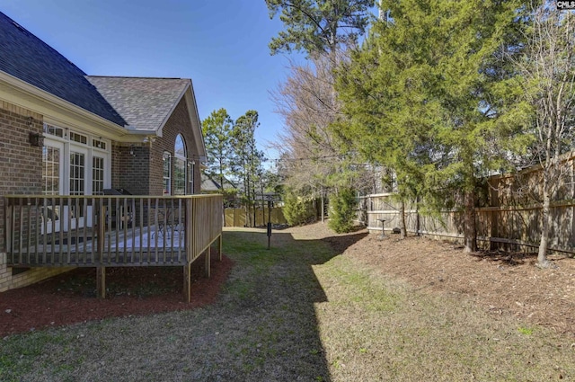 view of yard with a fenced backyard and a wooden deck