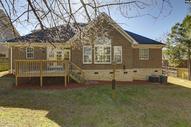 back of house with a yard, brick siding, crawl space, and fence