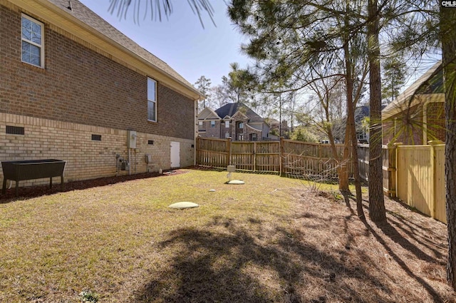 view of yard with a fenced backyard