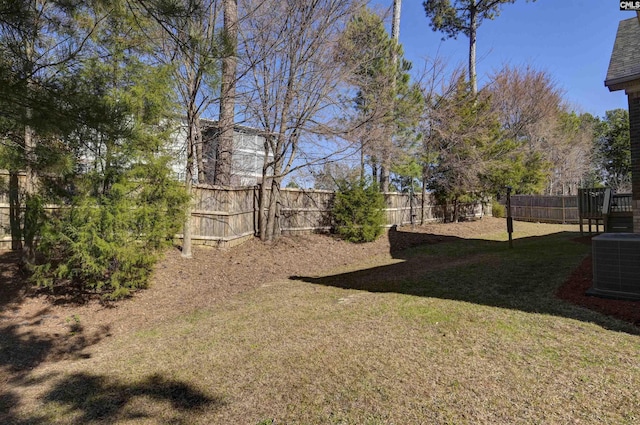 view of yard with central AC unit and a fenced backyard