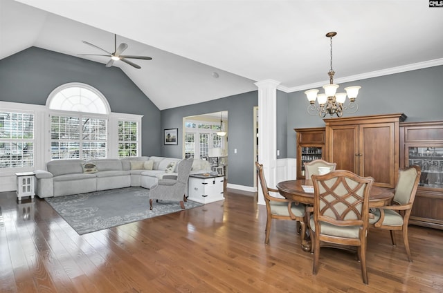 dining area featuring high vaulted ceiling, ceiling fan with notable chandelier, ornate columns, and wood finished floors