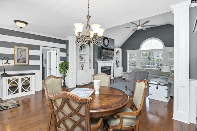 dining space with lofted ceiling, a fireplace, dark wood-style flooring, and ceiling fan with notable chandelier