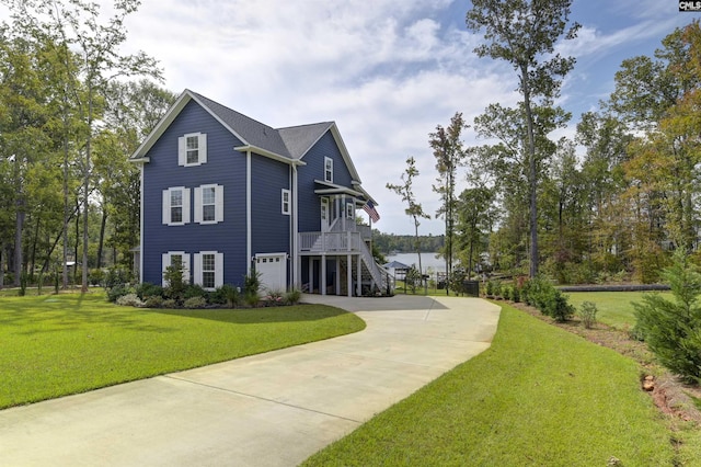 exterior space with concrete driveway, stairway, an attached garage, and a lawn