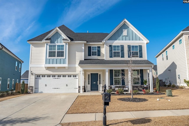 craftsman house with an attached garage, covered porch, concrete driveway, stone siding, and board and batten siding