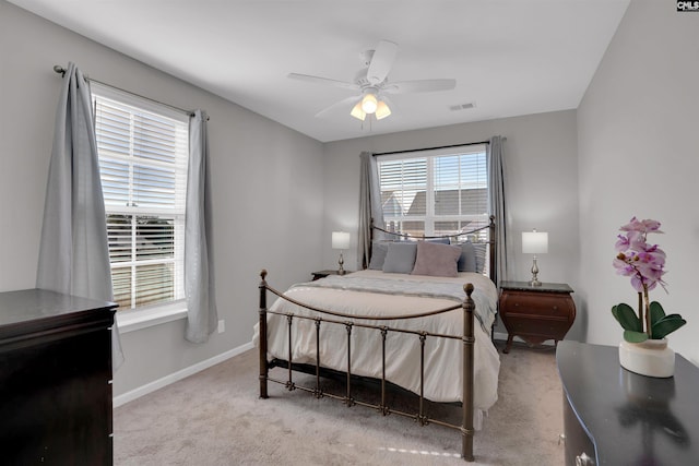 bedroom with carpet flooring, ceiling fan, visible vents, and baseboards