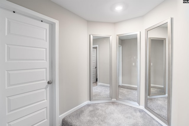 interior space featuring carpet floors and baseboards