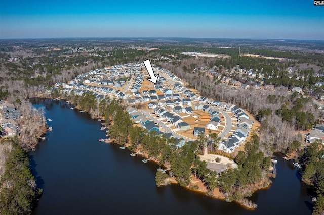 drone / aerial view with a forest view, a water view, and a residential view