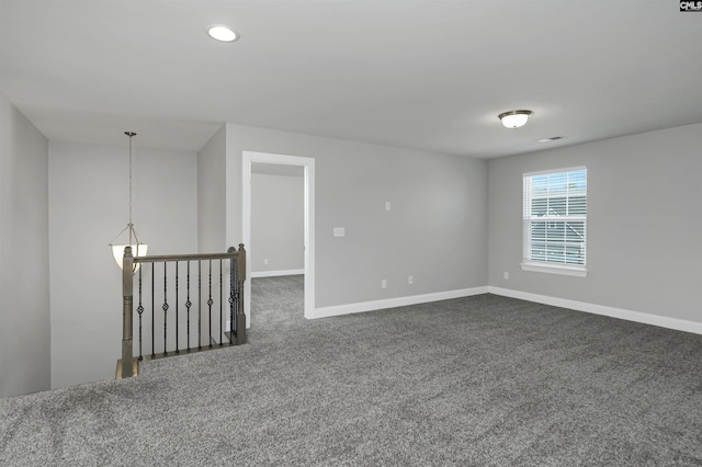 empty room with recessed lighting, visible vents, dark carpet, and baseboards