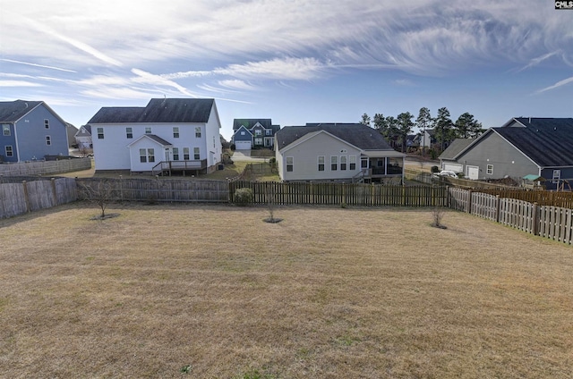 view of yard featuring a fenced backyard and a residential view